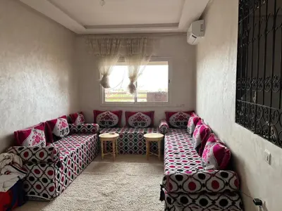 a living room with a couch and a window at Apparemment à Marrakech in Marrakech
