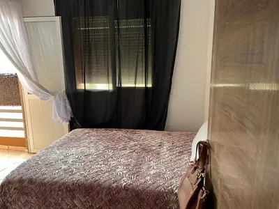 a bedroom with a bed with a black curtain at Apparemment à Marrakech in Marrakech