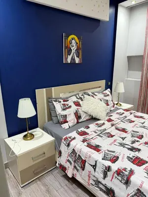 a bedroom with a bed and a blue wall at Bssatin gueliz in Marrakech