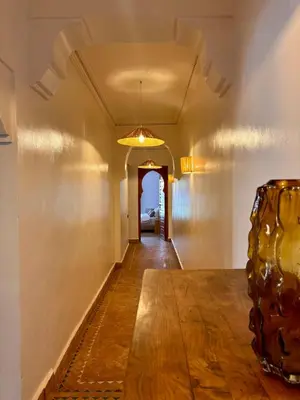 a hallway with a table and a vase at Villa Cactus & chill - Breakfast included! in Marrakech