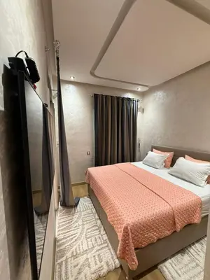 a bedroom with a bed and a television in it at Riad Garden Apartement & WiFi & Pool & Parking in Marrakech