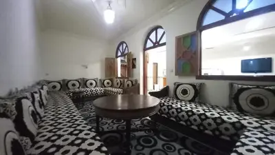 a room with black and white chairs and a table at Appartement 2 Chambres à Belbekkar, Marrakech in Marrakech