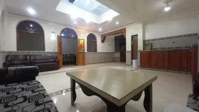 a large room with a table in the middle of it at Appartement 2 Chambres à Belbekkar, Marrakech in Marrakech