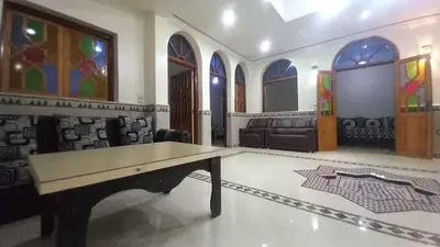 a living room with a table and a couch at Appartement 2 Chambres à Belbekkar, Marrakech in Marrakech