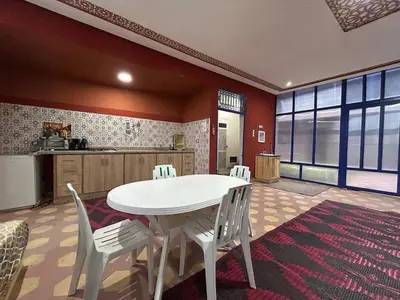 a kitchen with a white table and white chairs at Maison d'hôtes Marrakech in Marrakech