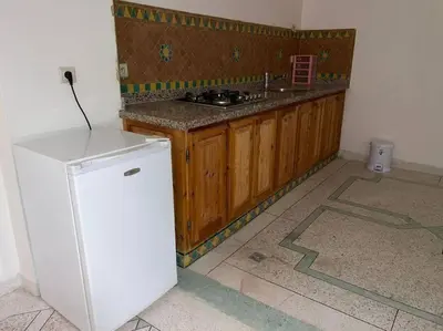a kitchen with a white refrigerator in a room at Appartement 3 chambres - Marrakech Belbekkar in Marrakech