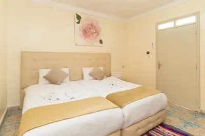 a bedroom with a large bed with white sheets at Riad Hbibti Authentic Moroccan Stay with Rooftop Jacuzzi in Marrakech