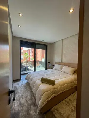 a bedroom with a large bed with a large window at Apartment for rent in Marrakech