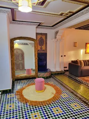a room with a mirror and a rug on the floor at Guéliz Marrakech-Authentique, spacieux , central in Marrakech