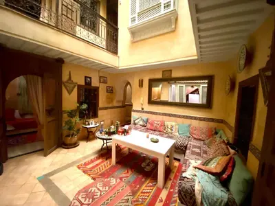 a living room with a couch and a table at Riad Sylvia in Marrakech