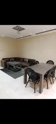a living room with a couch and a table and chairs at Chambre Marrakech 3 in Marrakech