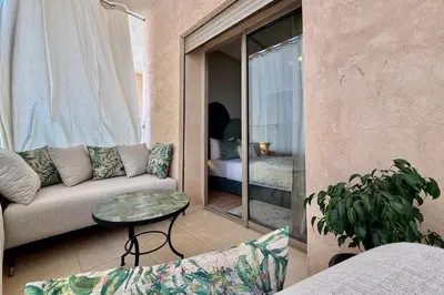 a living room with a couch and a table at Modern 2-Bedroom Apartment in Agdal with Pool & Terrace in Marrakech