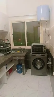 a kitchen with a washing machine in a room at Kawtar in Marrakech