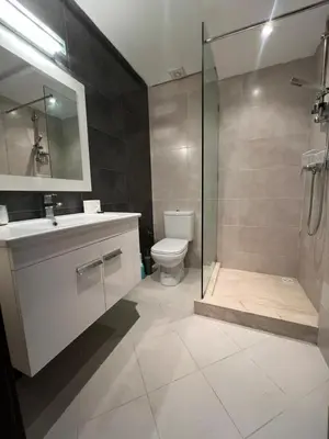 a bathroom with a shower and a sink and a toilet at Appartement neuf & moderne avec clim, piscine & balcon,Proche Jemaa el-Fna & Guéliz in Marrakech
