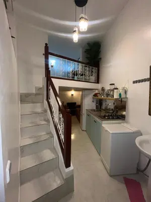 a kitchen with a staircase and a sink in a room at Appartement neuf bien situé in Marrakech