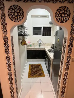 a kitchen with an arched doorway leading into a kitchen at Appartement neuf bien situé in Marrakech