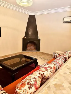 a living room with a couch and a fireplace at charming mini villa in Marrakech