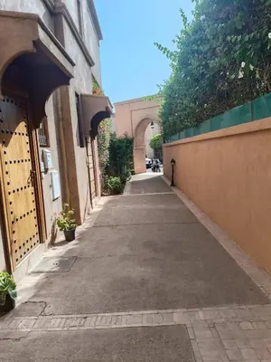 an empty alley with an archway in a building at charming mini villa in Marrakech