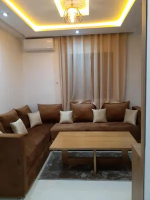 a living room with a couch and a coffee table at Appartement cosy à 8 min de RAK à pied in Marrakech