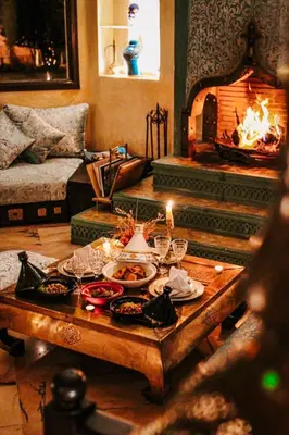 a living room with a table with food and a fireplace at La Villa Wassim in Marrakech