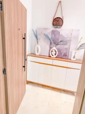 a room with a cabinet with vases on it at Modern apartment in Gueliz Luxury residence in Marrakech