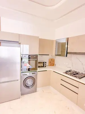 a kitchen with a washer and dryer in it at Modern apartment in Gueliz Luxury residence in Marrakech