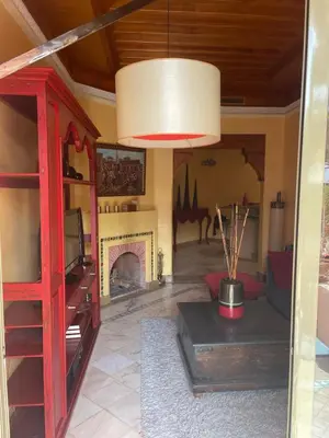 a living room with a tv and a fireplace at Appartement les jardins de la Palmeraie III in Marrakech