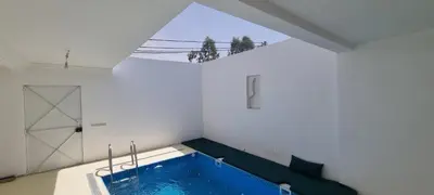 a bathroom with a large blue tub in a room at VILLA Malaika in Marrakech