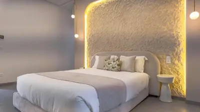 a bedroom with a white bed and a yellow wall at Villa SLIMANE - Villa plain-pied sans vis à vis in Marrakech