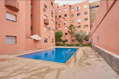 a swimming pool in the courtyard of a building at Appart VIP 5 étoiles et romantique à Guéliz avec Piscine, Clim, Parking et Wifi haut débit 200 Mb in Marrakech
