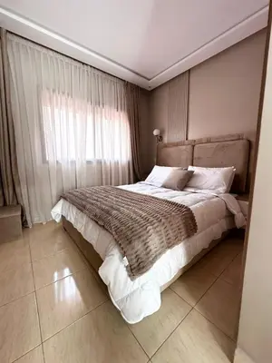 a bedroom with a large bed and a window at Homekesh in Marrakech