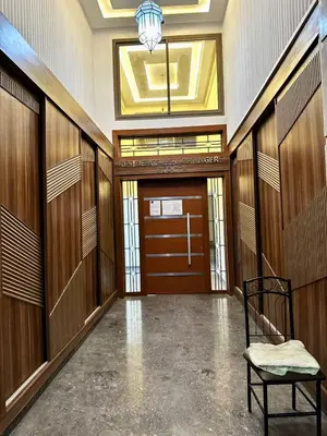 a hallway with a door and a chair in a building at Homekesh in Marrakech