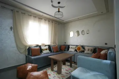 a living room with a blue couch and a table at Dar lalla in Marrakech
