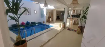 a house with a swimming pool in a living room at Villa NAIM in Marrakech