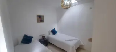 a white room with a bed and a chair at Villa NAIM in Marrakech