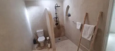 a small bathroom with a toilet and a shower at Villa NAIM in Marrakech