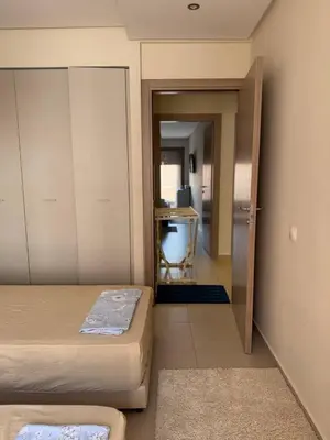a small room with two beds and a desk at Near Gueliz 2 Bedrooms 3 ACs Fast WiFi Netflix in Marrakech