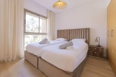 a bedroom with a large bed with a window at Beautiful 3 bedroom apartment for 6 people Prestigia Golf Saphir in Marrakech