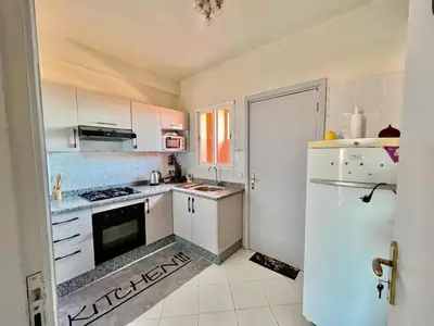 a kitchen with white cabinets and a refrigerator at NF15 by Majestic Properties in Marrakech