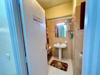 a bathroom with a sink and a shower with a dog bed at NF15 by Majestic Properties in Marrakech
