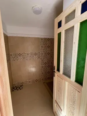 a bathroom with a shower with a glass door at Riad Maaffar in Marrakech
