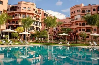 a swimming pool in front of a building at Elegant Appartement pool&terrace Marrakech in Marrakech