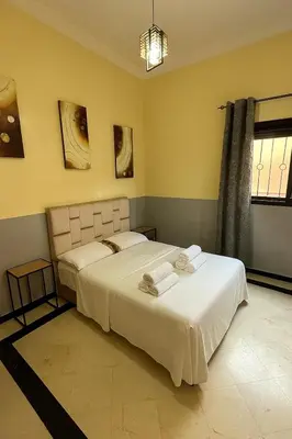 a bedroom with two beds and a window at Apartment NE 4 by Majestic Properties in Marrakech