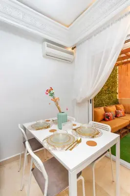 a white dining room with a white table and chairs at Au cœur du centre ville Gueliz a coté de Carre Eden et Plaza in Marrakech