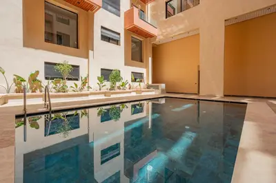 an indoor swimming pool in a house with a building at The Marrakech Mosaic A Fusion of Style city Central in Marrakech