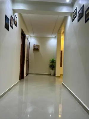 an empty hallway with a plant on the wall at Appartement familière luxe hay menara in Marrakech