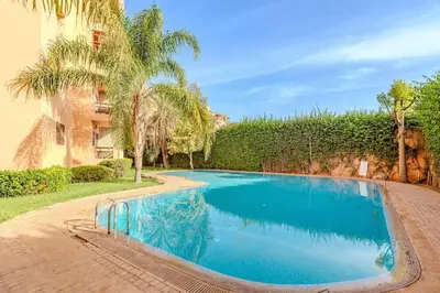 a swimming pool in a yard with palm trees at Wintering I Authentic Accommodation I Pool in Marrakech