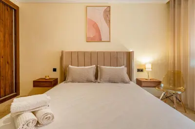 a bedroom with a large bed with towels on it at Atlas Dream Studio pool & parking included in Marrakech