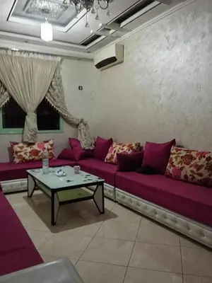a living room with purple couches and a table at شقة بغرفتين نوم لك بالكامل in Marrakech