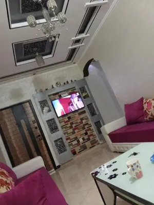 a living room with a couch and a tv at شقة بغرفتين نوم لك بالكامل in Marrakech